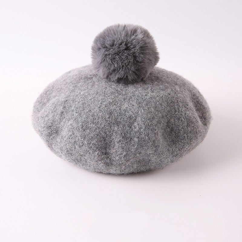 Girls' Pom Pom Beret shown in a child's bedroom – stylish and cosy choice for girls from Little Pirates.