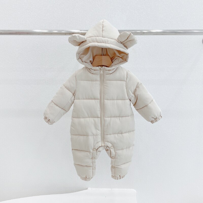 Detail of hood and zip on the cosy all-in-one winter snowsuit for little girls.