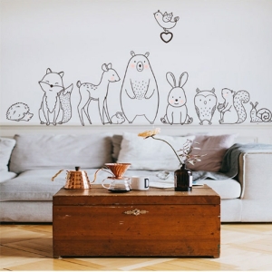Black and white animal motif wall decoration for girls, shown in a living room setting.