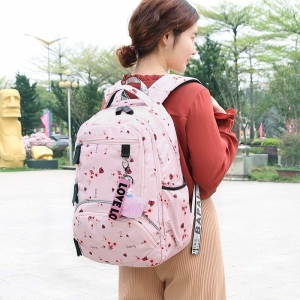 Floral School Bag for Girls in pink, modelled by a young girl – a fun and playful gift for girls from Little Pirates.