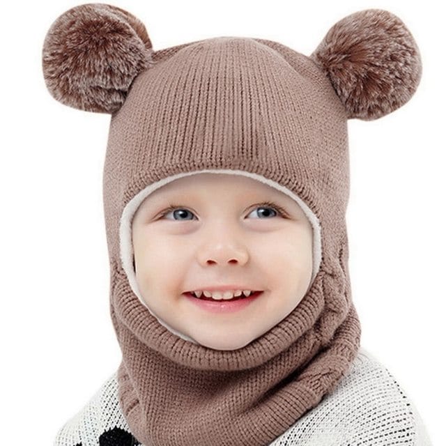 Side detail of the double pompom balaclava for girls, highlighting the soft fabric and fun pompom trim.