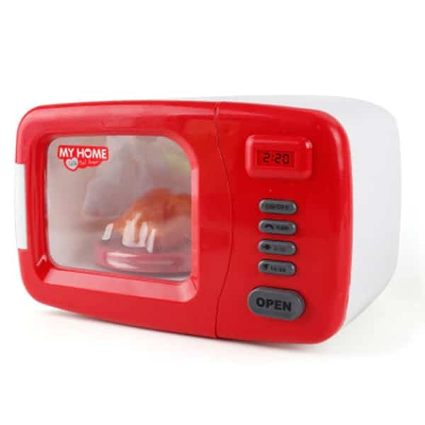 Play scene with the red and white toy microwave oven for girls, encouraging creative kitchen role play.