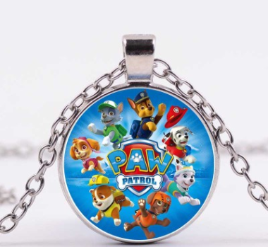 Close-up of the round Paw Patrol heroes pendant necklace with all the characters in colourful detail.