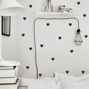 Full room view of the heart-shaped wall sticker in a girl's bedroom, showing how it transforms the space.