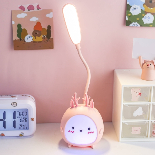 Pink bunny rabbit LED night light for girls displayed on a table next to a clock.