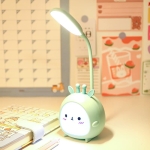 Pink bunny rabbit LED night light creating a soft glow on a girl's bedside table.