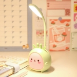 Close-up of the pink bunny rabbit LED night light glowing on a bedside table.