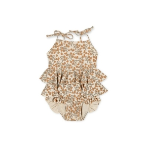 Detail of the ruffles and floral pattern on the summer swimsuit for girls.