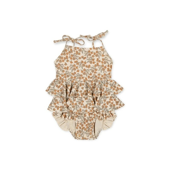 Detail of the ruffles and floral pattern on the summer swimsuit for girls.
