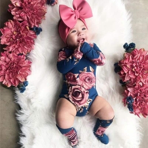 Sweet girls romper with matching socks worn by a little girl, a perfectly coordinated and playful outfit set for baby girls.