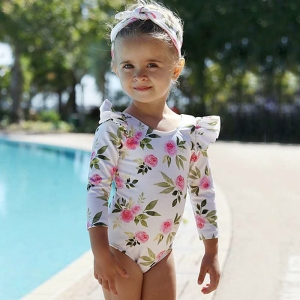 A girls' beach one-piece swimsuit shown on a flat surface, colourful and easy-to-wear for summer fun