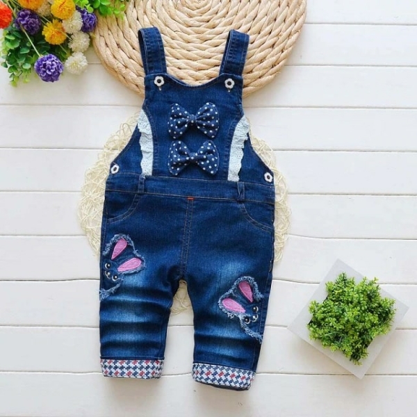 A girls' denim dungaree dress, a chic and relaxed denim outfit perfect for spring and summer