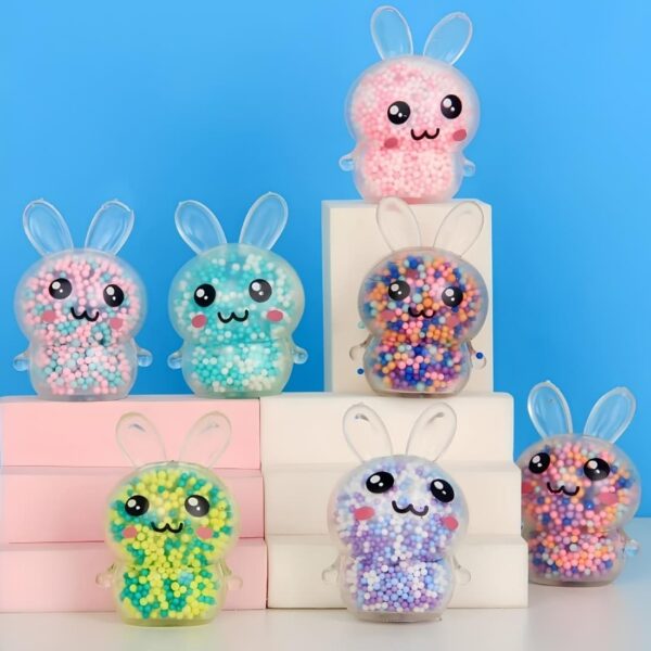 A pack of three squishy rabbit bead stress balls in transparent stretchy plastic with colourful beads inside, displayed on a blue background.