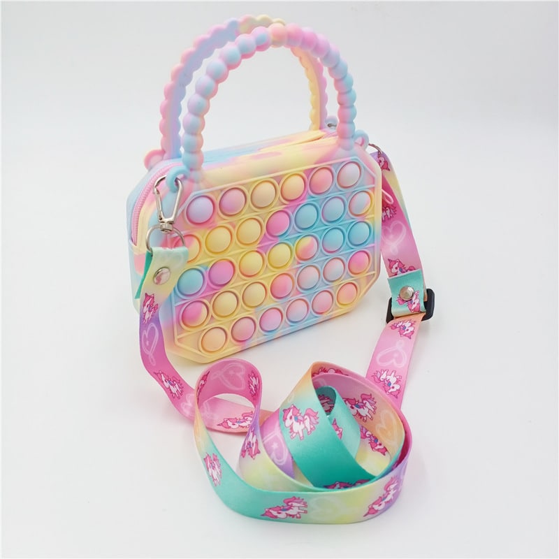 A girl carrying the colourful Pop It silicone handbag, enjoying its fun and sensory-friendly design.