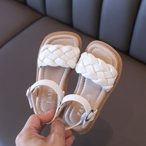 Side view of braided leather summer sandals for little girls, displaying the elegant strap design and comfortable, sturdy sole.