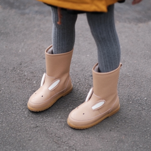 A pair of warm leather boots with cute bunny pattern for little girls, cosy and stylish for winter adventures.