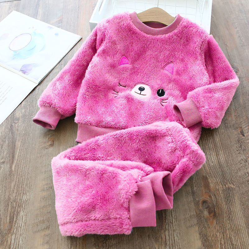 Close-up of the soft polar fleece fabric on girls winter pyjamas, showing the warm brushed texture and cosy construction.