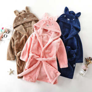 Three adorable girls hooded dressing gowns in beige, pink, and blue, each with cute rabbit ears on the hood.