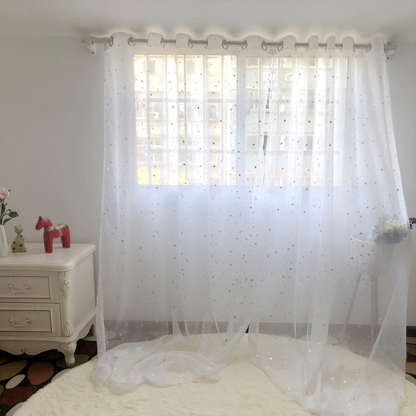 White Tulle Bedroom Curtain with Silver Star Print for Girls hanging in a window, adding a magical touch to a girl's bedroom.