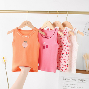 Four colourful sleeveless cotton vests for girls hanging on clothes hangers, bright and perfect for everyday wear.