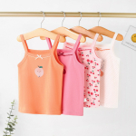 Four colourful strappy cotton vests for girls hanging on clothes hangers, soft and perfect for warm days.