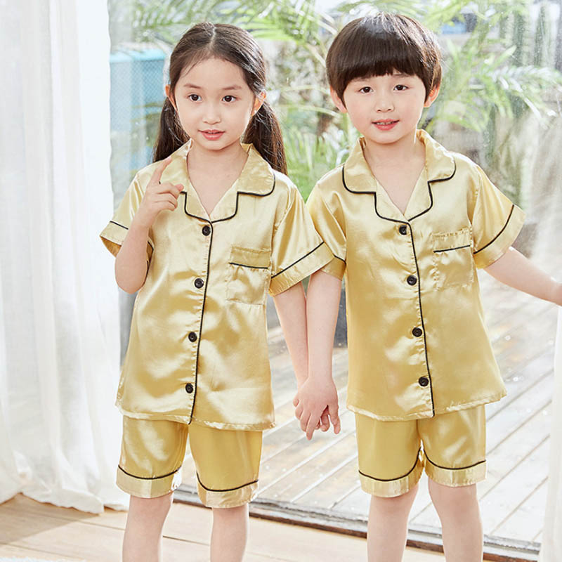 Detail view of the silky satin fabric and relaxed fit of the summer pyjama set for girls