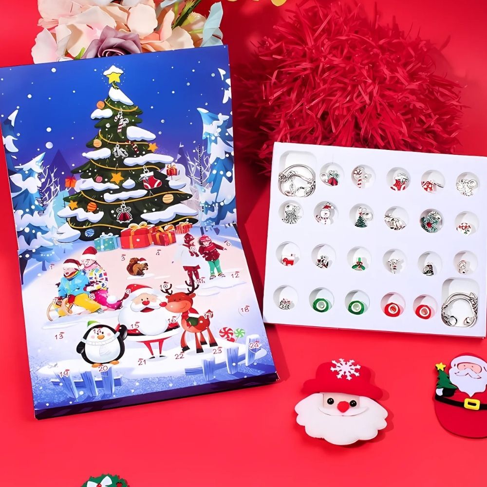 The full contents of the Christmas Advent calendar with jewellery charms laid out, including bracelets, charms, and the rectangular Christmas-decorated calendar box.