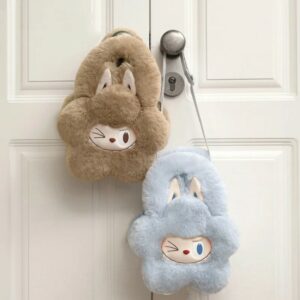 Close-up of the soft blue flower-shaped Labubu handbag showing the winking face, large rabbit ears, and fluffy texture.