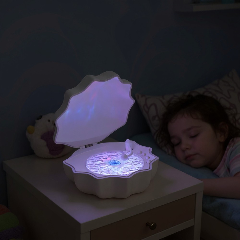 Shell Bluetooth night light projecting gentle ocean-inspired light patterns across a darkened room for a cosy, dreamy effect.