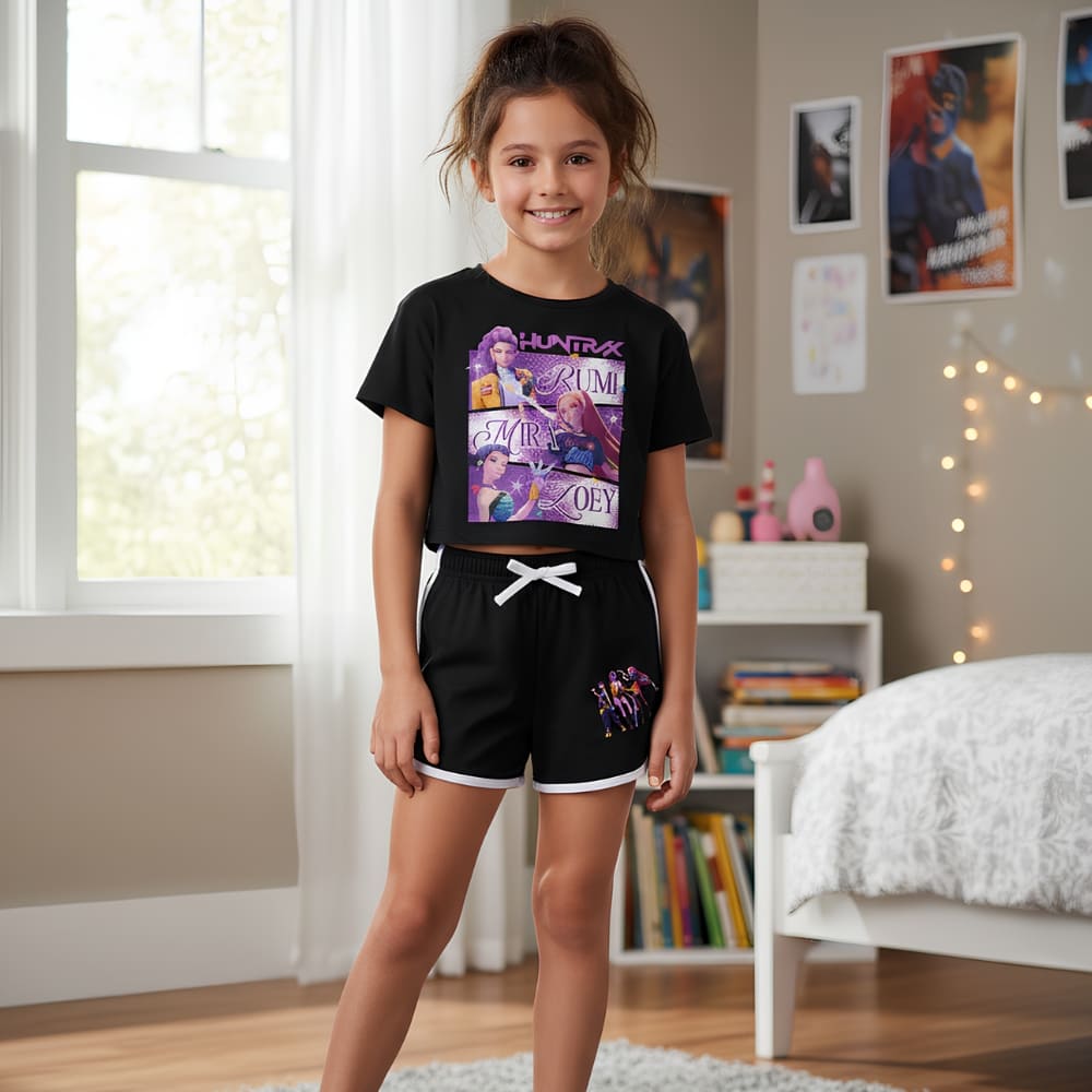 Close-up of the black K-pop Demon Hunters short-sleeve pyjama top showing the colourful character print of Zoey, Mira, and Rumi on the front.