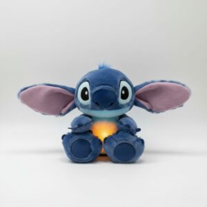 Stitch breathing night light plush toy on a grey background, softly glowing as it gently rises and falls, a soothing and cuddly bedtime companion for children.