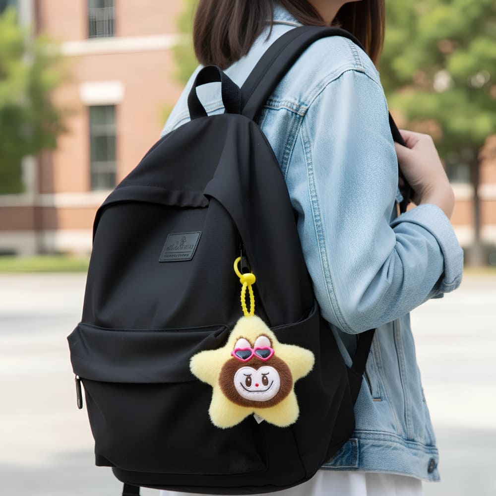 Close-up of the Labubu-style star plush keyring showing the cute brown Labubu face with pink heart sunglasses and textured plush surface.