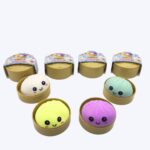 Four colourful squishy dumpling mystery boxes with four different model squishies displayed in front, fun surprise gifts for girls.