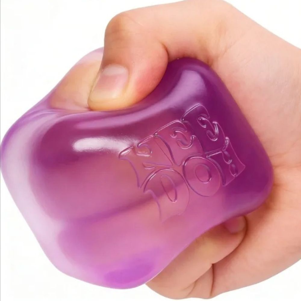 Close-up of the Needoh ice cube sensory toy showing the translucent gel-like surface texture in pink, blue, and violet colour options.