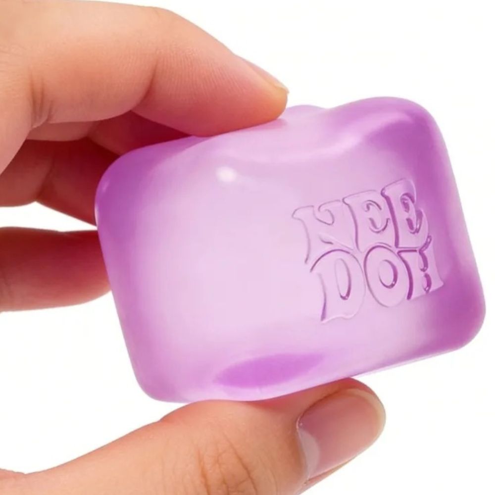 Needoh ice cube sensory toys shown inside their square packaging boxes, displaying the product and branding for each pastel colour variant.