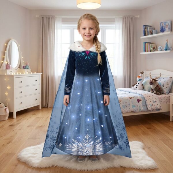 Little girl in her bedroom wearing an Elsa Frozen LED princess dress with a winter cape, glowing white lights on dark blue velvet